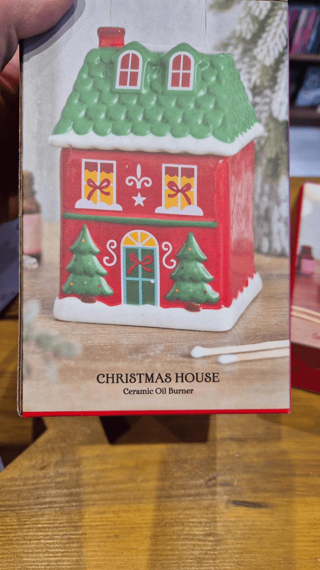 Christmas House Oil Burner by Merch — book cover